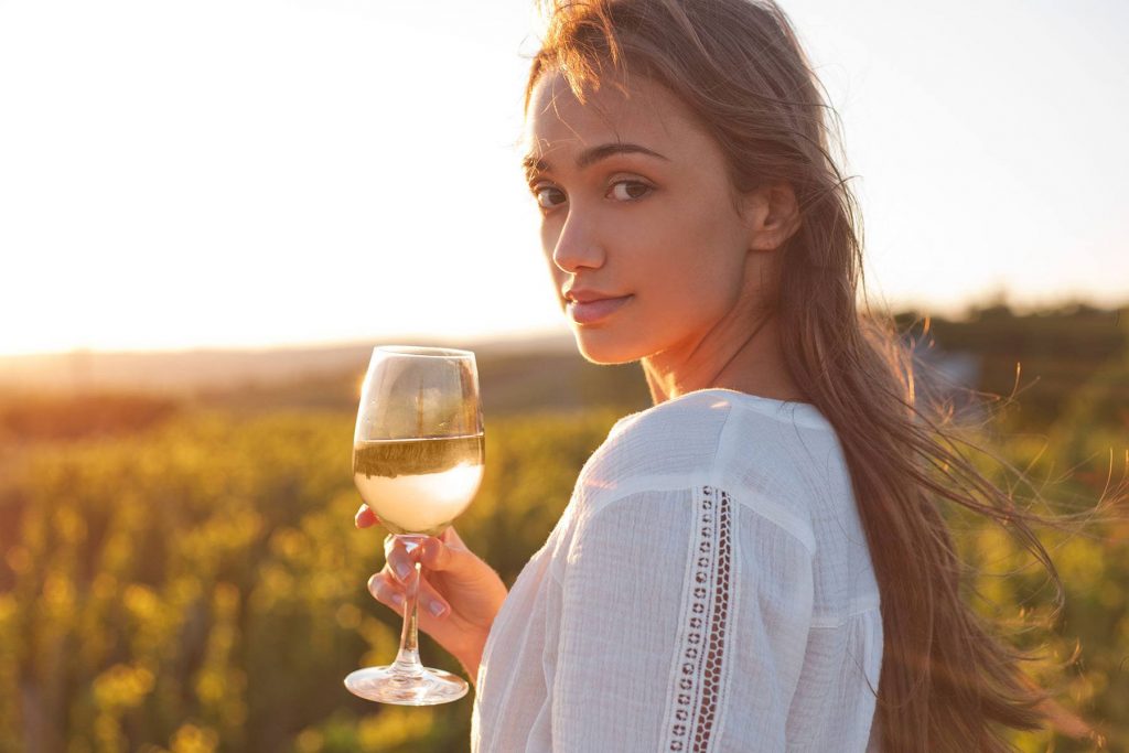 a girl holding a glass of wine